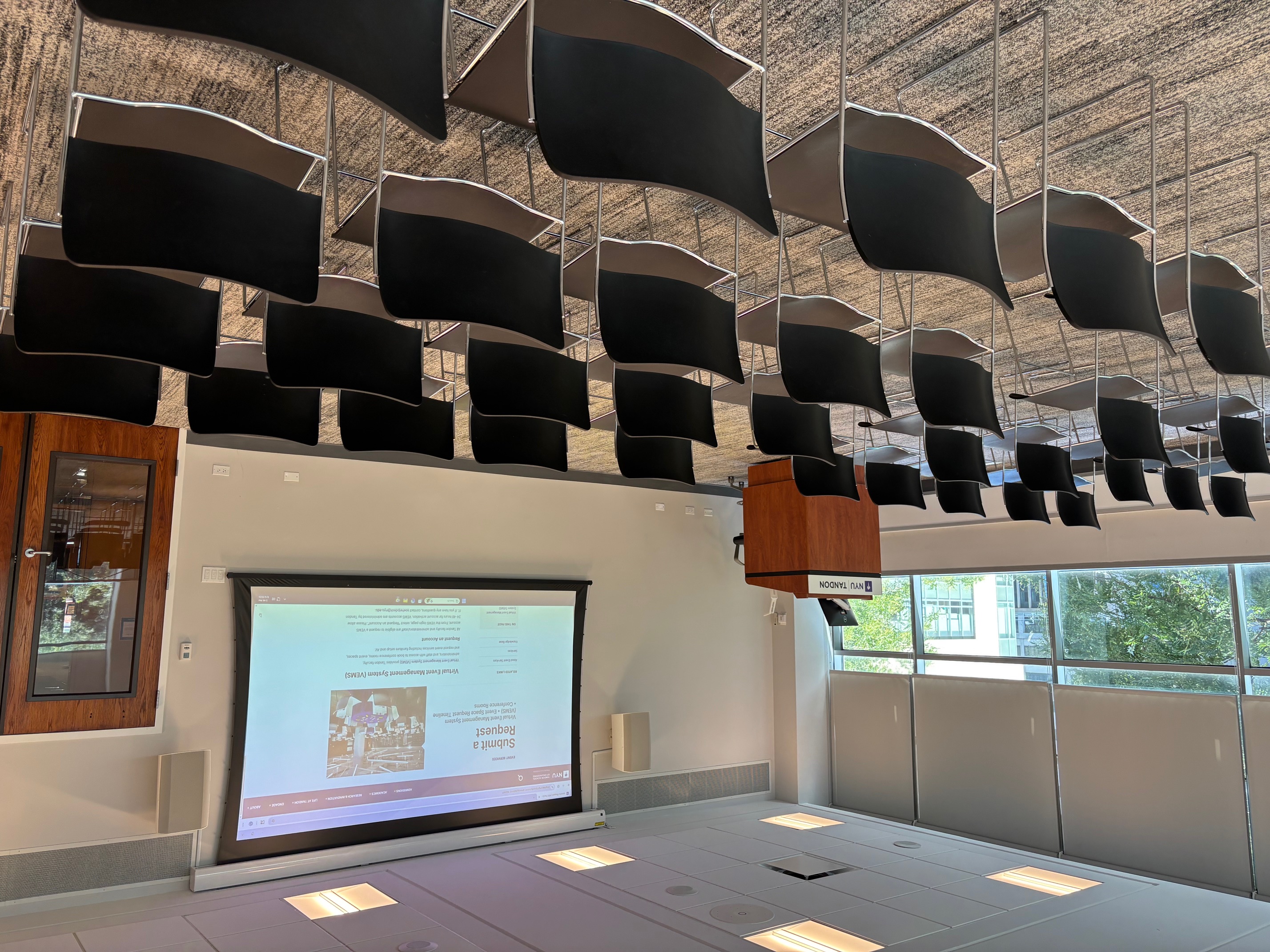 Room with rows of chairs and projection screen