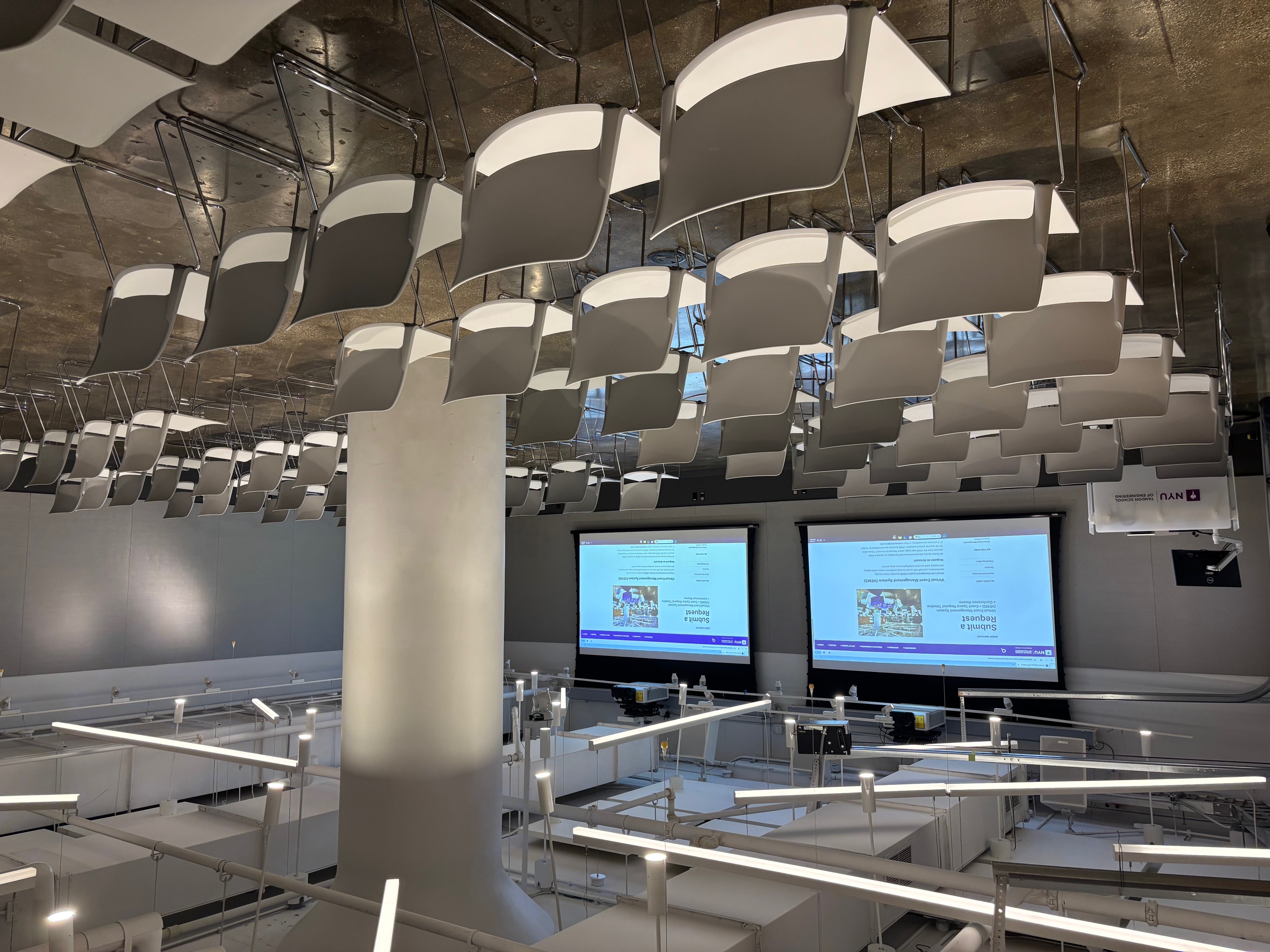 Room with rows of chairs and projection screen