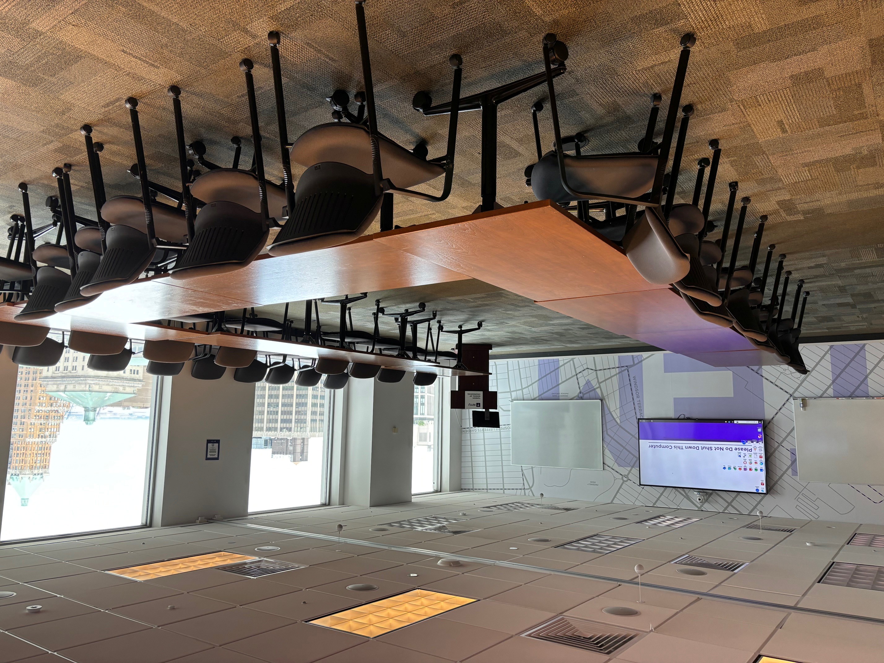 Room with tables and chairs and large windows